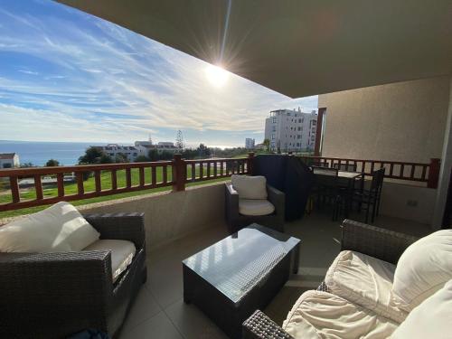 a balcony with couches and a table and a view of the ocean at Departamento Puerto Velero in Tongoy