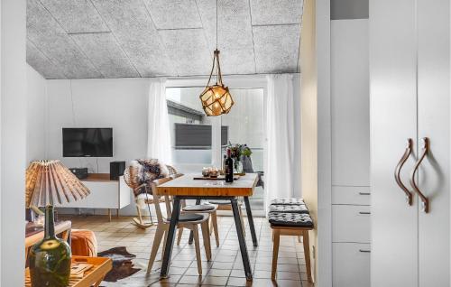a kitchen and dining room with a table and chairs at Awesome Apartment In Løkken With Wifi in Løkken