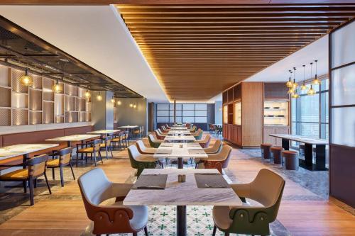 a row of tables and chairs in a restaurant at Four Points by Sheraton Xi’an High-Tech Zone in Xi'an