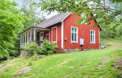 a red house sitting on top of a hill at Cozy Home In Asarum With Wifi in Asarum