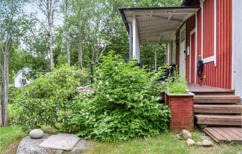 a porch of a red house with a red building at Cozy Home In Asarum With Wifi in Asarum