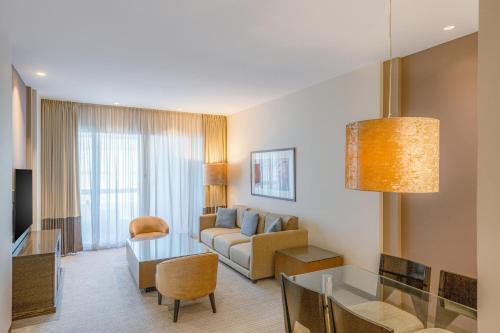 a living room with a couch and a table at Four Points by Sheraton Al Ain in Al Ain