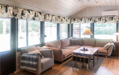 a living room with a couch and a table at 2 Bedroom Stunning Home In Örkelljunga in Fasalt