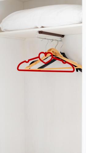 a hanger with a heart sign on a wall at Giardini Malaspina in Bosa
