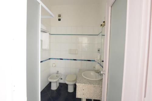 a bathroom with a toilet and a sink at Hotel Tourist in Turin