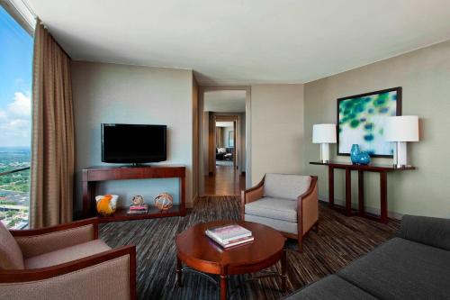 a living room with a couch and a tv at The Westin Peachtree Plaza, Atlanta in Atlanta
