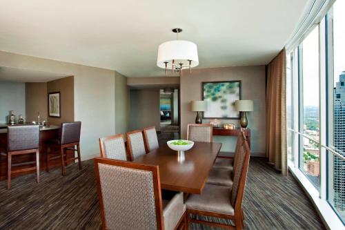 a dining room and living room with a table and chairs at The Westin Peachtree Plaza, Atlanta in Atlanta