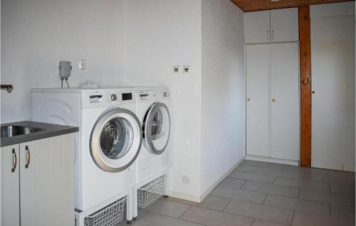 a white laundry room with a washer and dryer at Amazing Home In Klagstorp With Wifi in Klagstorp