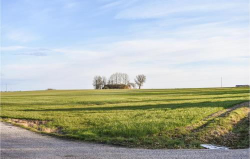 a field of green grass next to a road at Amazing Home In Klagstorp With Wifi in Klagstorp