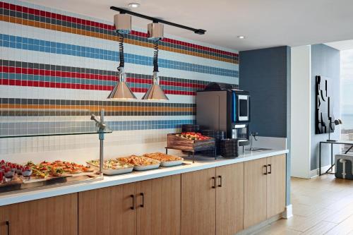 a buffet line with pizzas on display in a kitchen at Delta Hotels by Marriott Toronto in Toronto