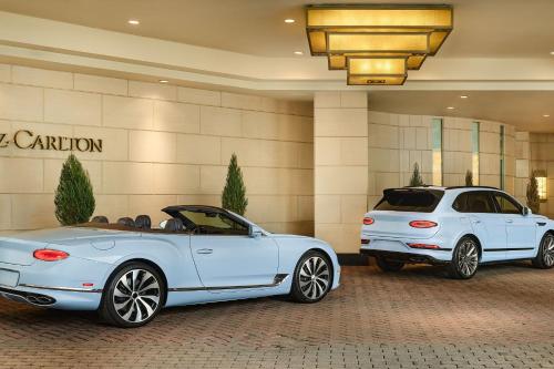 two white cars parked in front of a building at The Ritz-Carlton, Denver in Denver