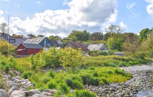 a village with a river and houses at Stunning Home In Simrishamn With Wifi in Simrishamn