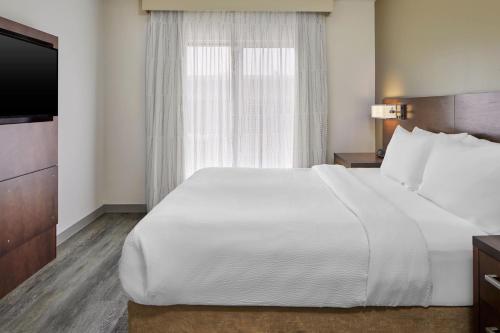 a bedroom with a large white bed and a window at Residence Inn Atlanta Perimeter Center Dunwoody in Atlanta