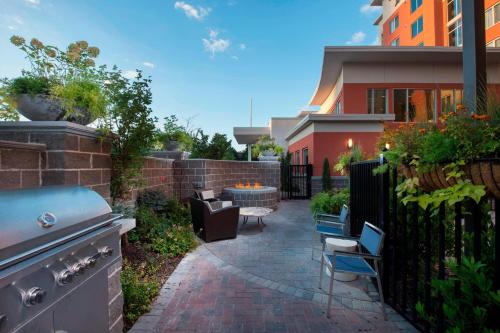 a patio with a grill and chairs and a building at Residence Inn Atlanta Perimeter Center Dunwoody in Atlanta