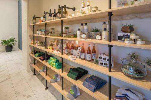 a room with wooden shelves filled with bottles at The Hi-Lo, Autograph Collection in Portland
