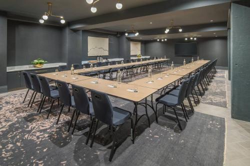 a large conference room with a long table and chairs at The Hi-Lo, Autograph Collection in Portland