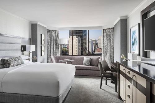 a hotel room with a bed and a couch at The Ritz-Carlton Atlanta in Atlanta