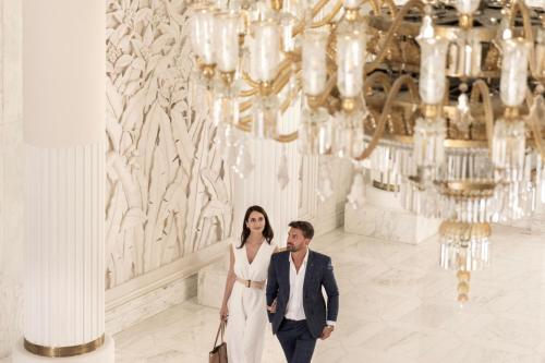 a bride and groom pose for a picture in the lobby of a building at The Ritz-Carlton Rabat, Dar Es Salam in Rabat