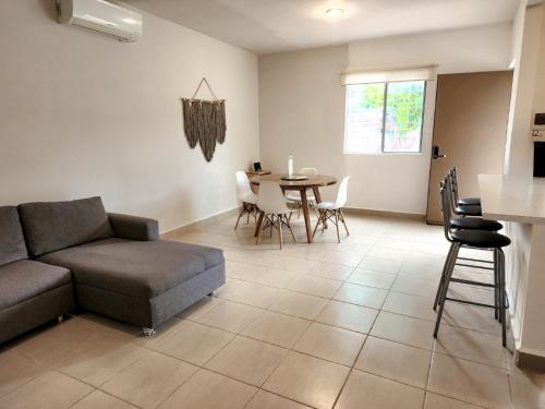 a living room with a couch and a table at El Faro 2bed 1 bath gated neighborhood with pool in Puerto Morelos