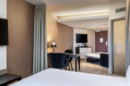 a hotel room with a bed and a desk at AC Hotel Paris Porte Maillot by Marriott in Paris