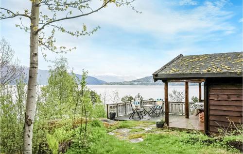 a cabin with a deck and a view of the water at 2 Bedroom Beautiful Home In Balestrand in Balestrand