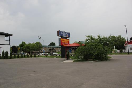 a gas station with a sign in a parking lot at Imperial Inn Thousand Islands in Gananoque