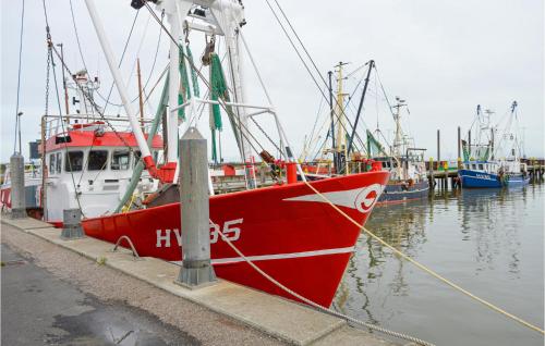 a red boat docked at a dock with other boats at Three-Bedroom Holiday Home In Romo in Kongsmark