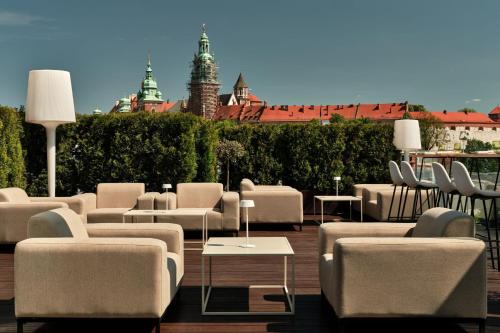 a group of chairs and tables on a patio at Sheraton Grand Krakow in Kraków
