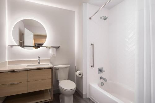 a bathroom with a toilet and a sink and a tub at TownePlace Suites by Marriott New Philadelphia in New Philadelphia