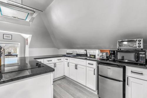 a kitchen with white cabinets and white appliances at 3rd Story Loft Islandview Pets Included with Free Parking! in Detroit