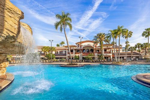 a pool with a fountain in front of a resort at Sheraton Vistana Villages Resort Villas, I-Drive Orlando in Orlando