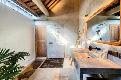 a bathroom with a sink and a mirror at Villa Manouch in Nusa Lembongan