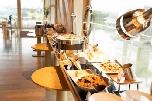 a buffet line with plates of food in a restaurant at Shonai Hotel Suiden Terrasse in Tsuruoka