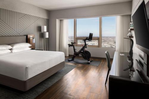 a hotel room with a bed and a exercise bike at Minneapolis Marriott City Center in Minneapolis