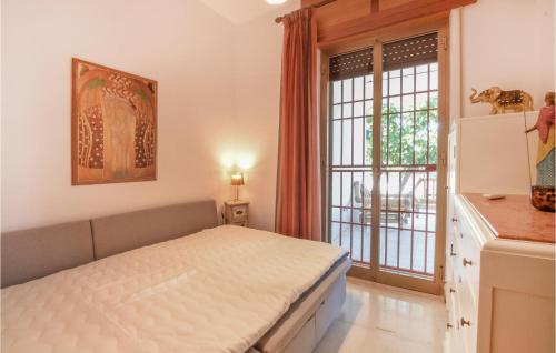 a bedroom with a bed and a large window at Lovely Home In Marina Di Modica in Marina di Modica