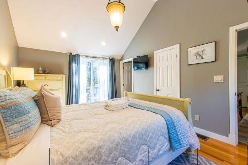 a bedroom with a bed and a window at Waterfront Cape Cod Home in Dennis Port