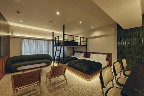 a bedroom with a bed and a bunk bed at illi Tas Shinjuku in Tokyo
