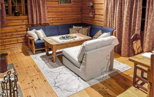 a living room with a blue couch and a table at 4 Bedroom Beautiful Home In Sälen in Stöten