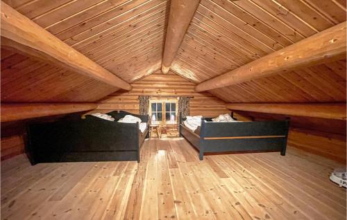 a room with two beds in a wooden attic at 4 Bedroom Beautiful Home In Sälen in Stöten