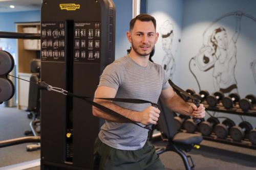 a man is exercising in a gym with a rope at Residence Inn by Marriott Munich Central in Munich