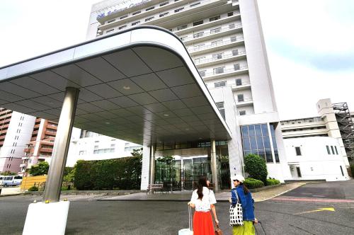 two women walking in front of a building at Bellevue Garden Hotel Kansai International Airport in Izumi-Sano