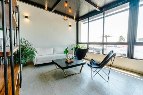 a living room with a couch and a table and chairs at Hotel NG in Ameca