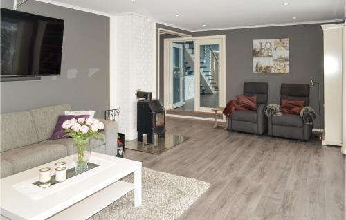 a living room with two couches and a table at Nice Home In Sandefjord With Wifi in Sandefjord