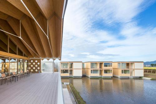 an exterior view of a building with water at Shonai Hotel Suiden Terrasse in Tsuruoka