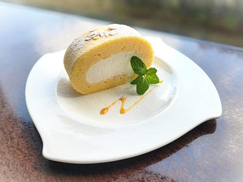 a piece of cake on a plate on a table at Bellevue Garden Hotel Kansai International Airport in Izumi-Sano