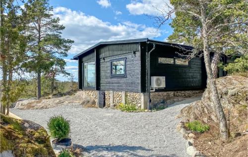 a house on a hill with a gravel driveway at Lovely Home In Sorunda With Kitchen in Grytnäs