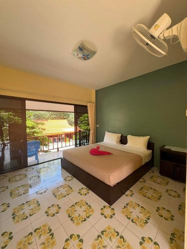 a bedroom with a bed with a view of a patio at Boonya Resort Koh Chang in Ko Chang