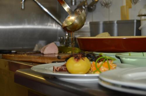 a plate of food on a counter in a kitchen at Auberge des Sauterelles in Sermersheim