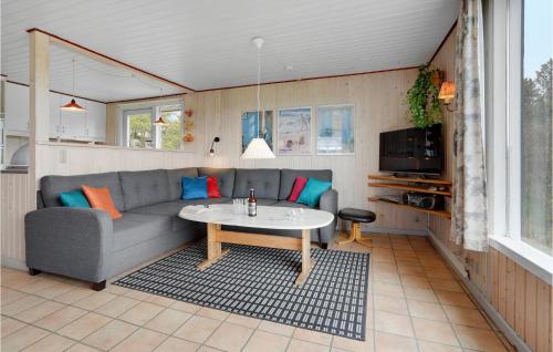 a living room with a couch and a table at Holiday Home Ringvejen Vi Denmark in Rømø