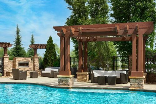 a wooden pergola next to a swimming pool at Residence Inn by Marriott Nashville South East/Murfreesboro in Murfreesboro